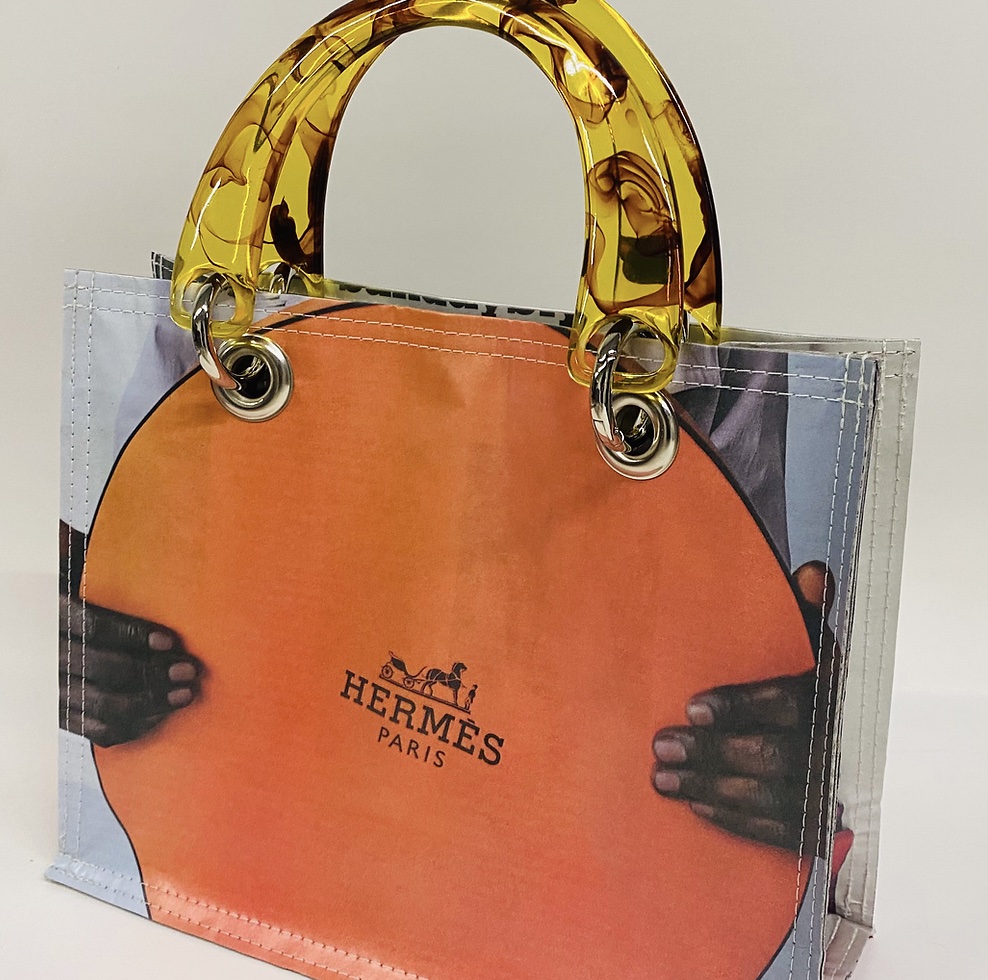 A handbag made from an Hermès scarf with an amber resin handle, by Couture Planet, shown at Gallery 9 in Norwood, Massachusetts