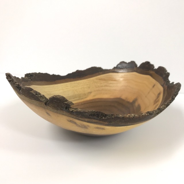 A turned wooden bowl with a natural live edge, shared on Instagram